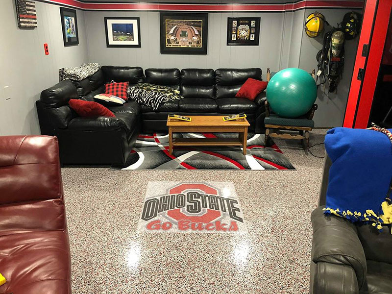 Man cave floor with epoxy flakes and logo