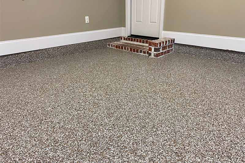 Epoxy garage floor coating at a home in Mobile, AL by Cornerstone Hard Surface Restoration in Theodore, AL